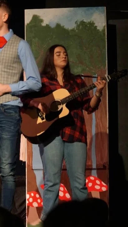 Marion Sulej holding a guitar in Galway